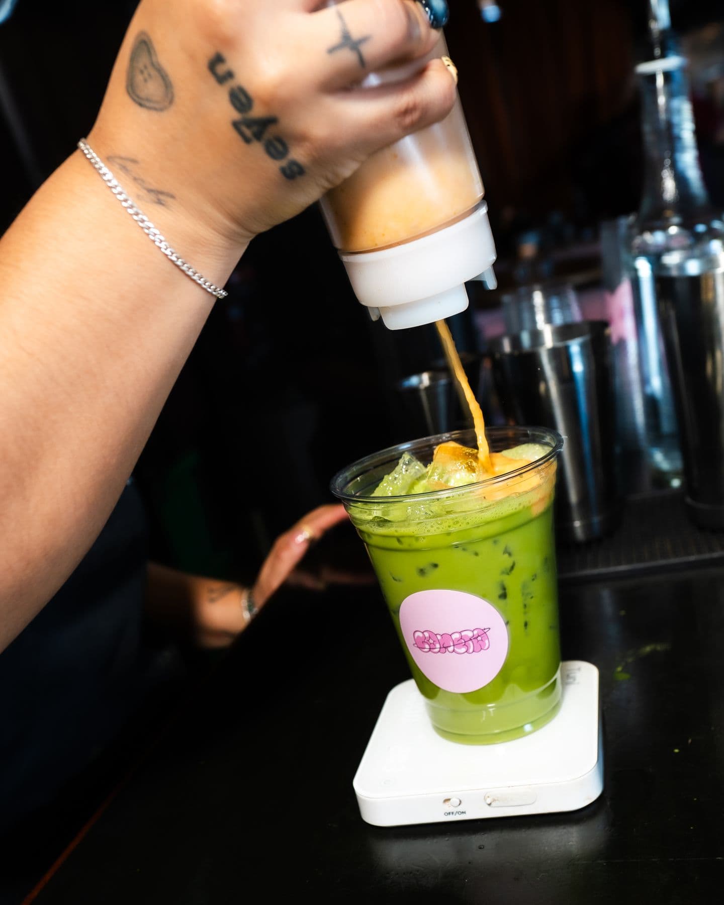 A matcha being poured at the bar