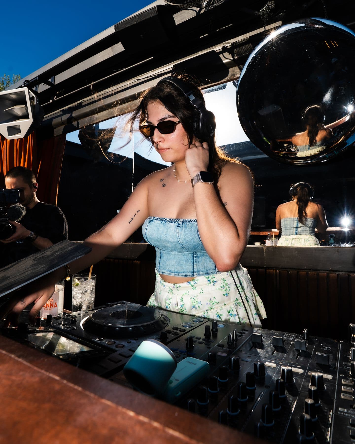A DJ under the giant mirror-ball domes