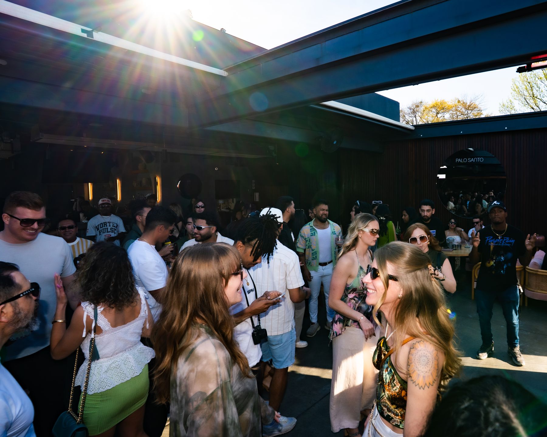 The rooftop crowd with the sun breaking through