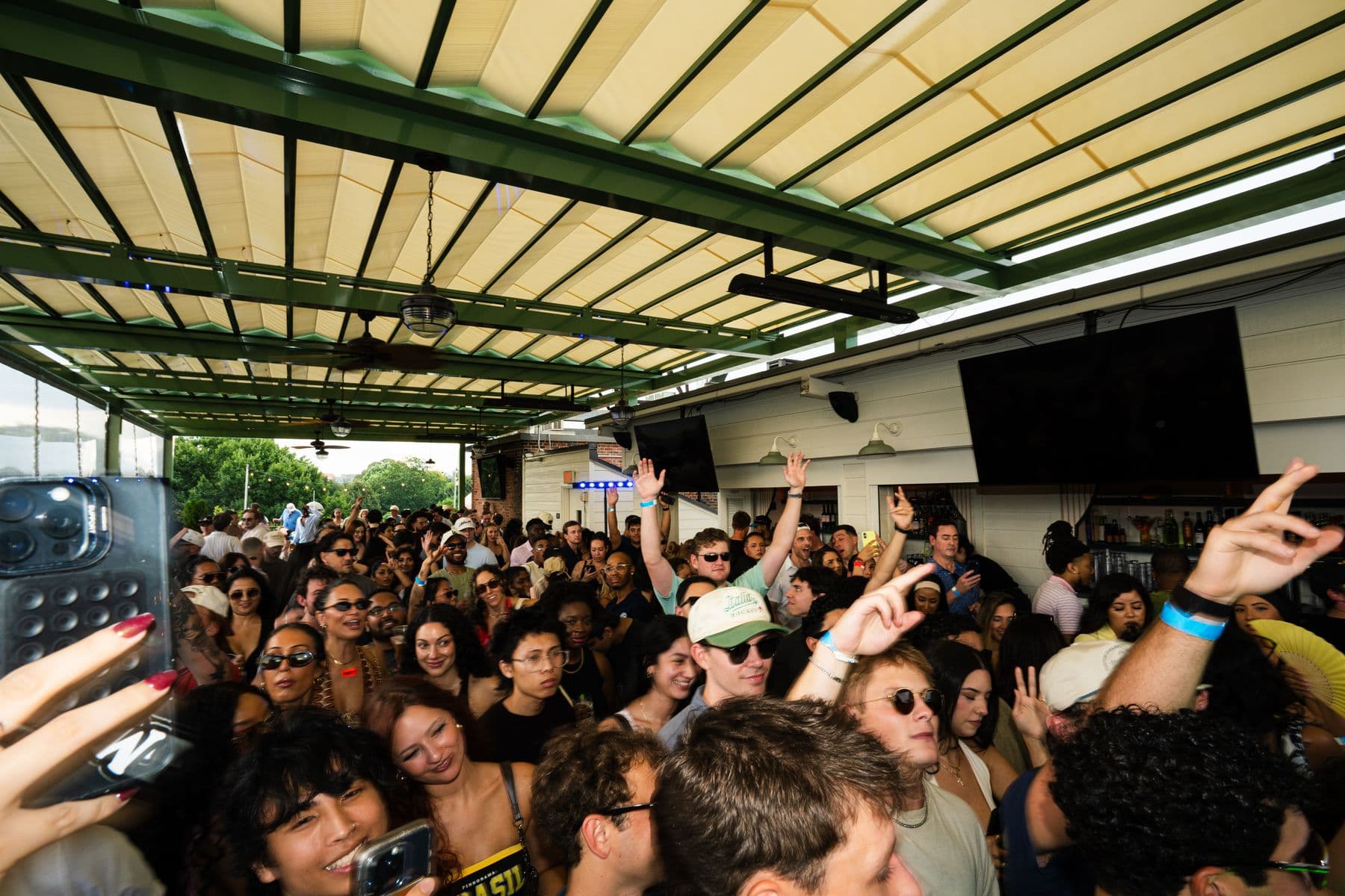 The crowd packed under the rooftop canopy